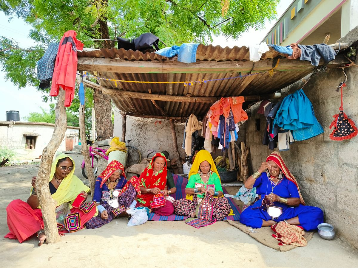 Banjara women engage in traditional embroidery work in Gangunaik thanda in Yadgir district.