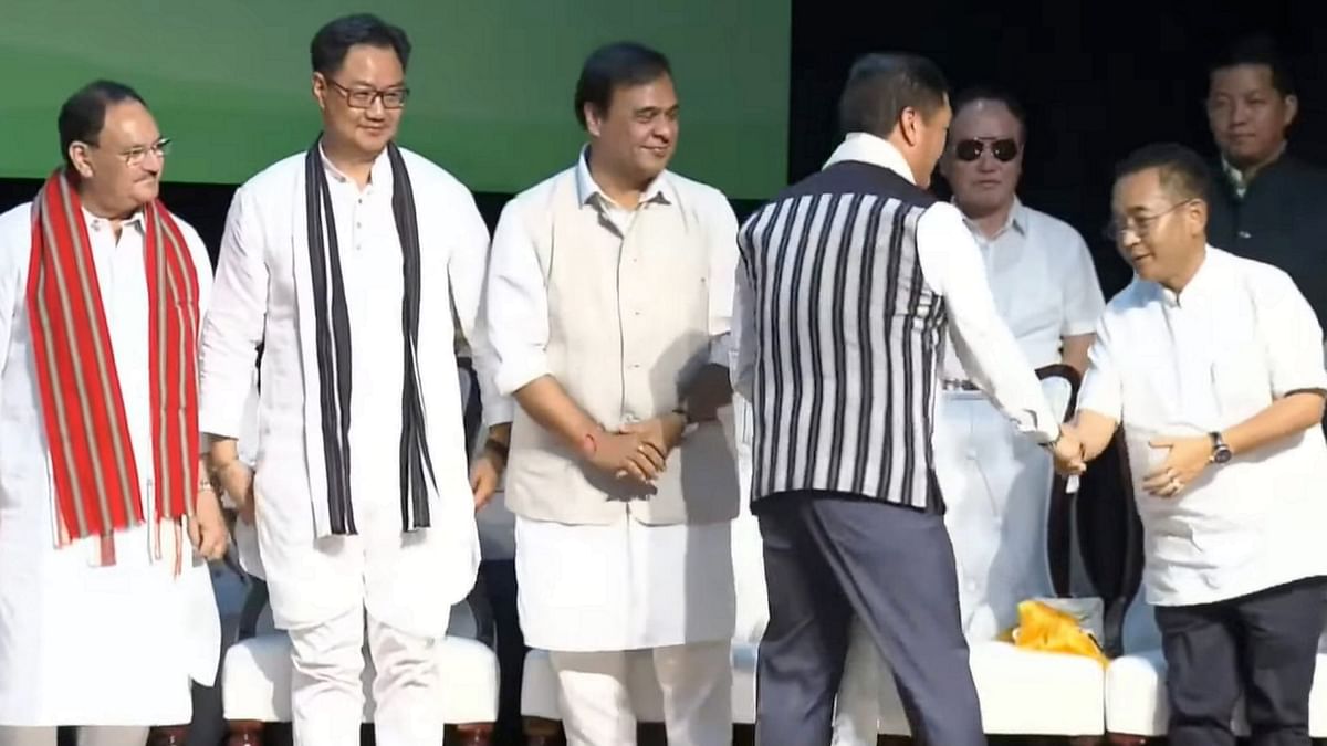 Arunachal Pradesh Chief Minister Pema Khandu being greeted by Sikkim CM Prem Singh Tamang as Assam CM Himanta Biswa Sarma and Union Ministers Kiren Rijiju and JP Nadda look on during the oath-taking ceremony of Pema Khandu, in Itanagar.