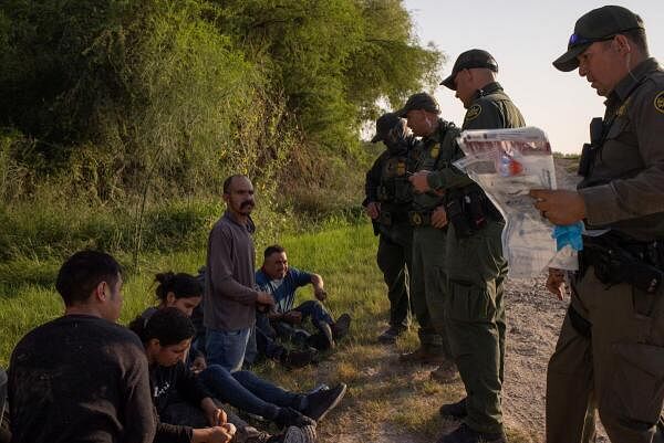 Migrants are processed after being detained for crossing into the United States from Mexico.