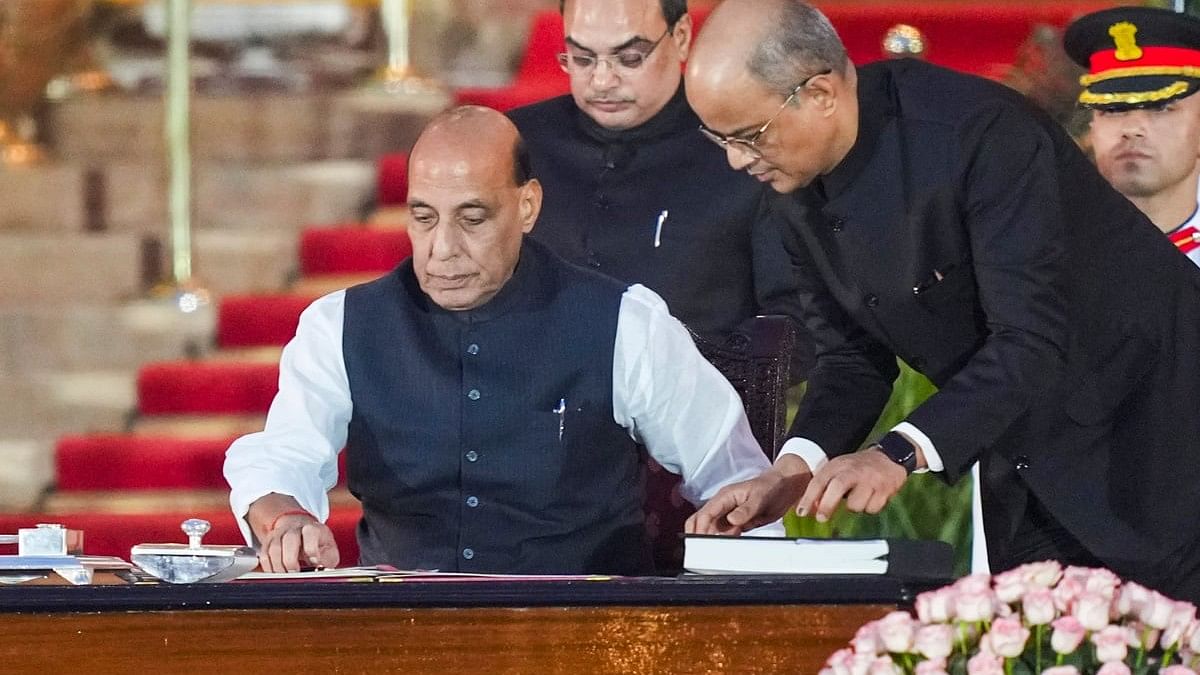 BJP leader Rajnath Singh takes oath as minister during the swearing-in ceremony of new Union government, at Rashtrapati Bhavan in New Delhi, Sunday.
