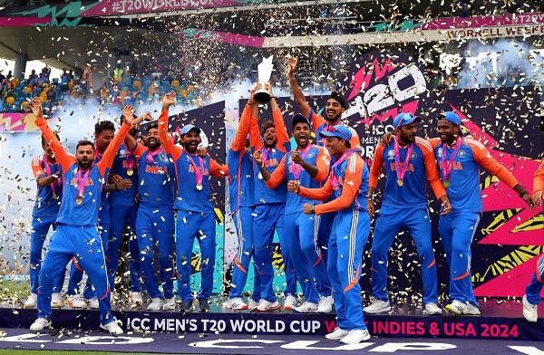 India's Kuldeep Yadav lifts the trophy as they celebrate after winning the T20 World Cup