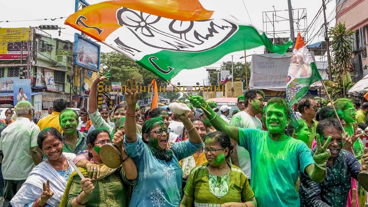 TMC supporters celebrate the party's lead during counting of votes for Lok Sabha elections, outside party supremo Mamata Banerjee's Kalighat residence, in Kolkata.