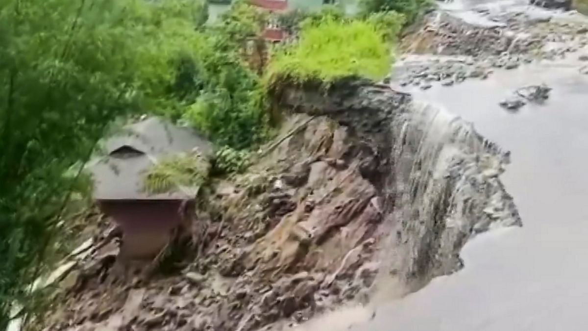 A section of a road collapsed due to a landslide triggered by incessant rainfall, at Mangan in North Sikkim.