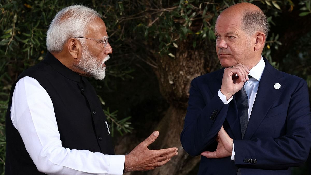 Prime Minister Narendra Modi is seen engrossed in a serious conversation with German Chancellor Olaf Scholz, in Italy.