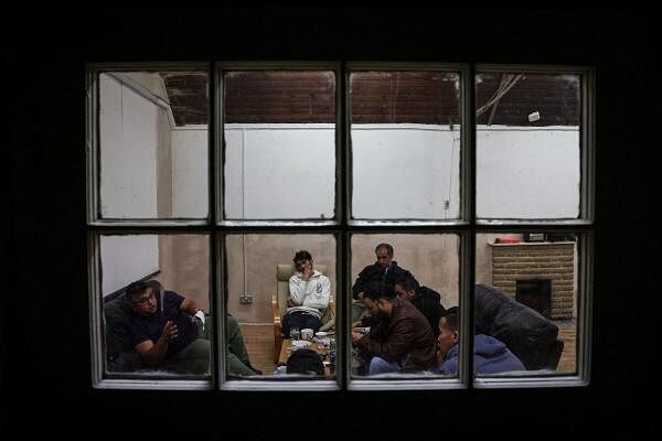 Squatters rest in a room used as a common room at their home, which was once a school and is now occupied by squatter activist group Reclaim Croydon, in Croydon, south London, Britain, May 16, 2024. The collective Reclaim Croydon, a group of squatters, has taken over disused commercial premises to provide beds for the homeless, saying it offers a community solution to a broken housing market.   