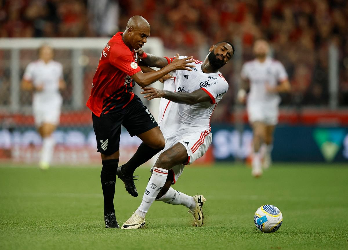 Athletico Paranaense's Fernandinho in action with Flamengo's Gerson. 