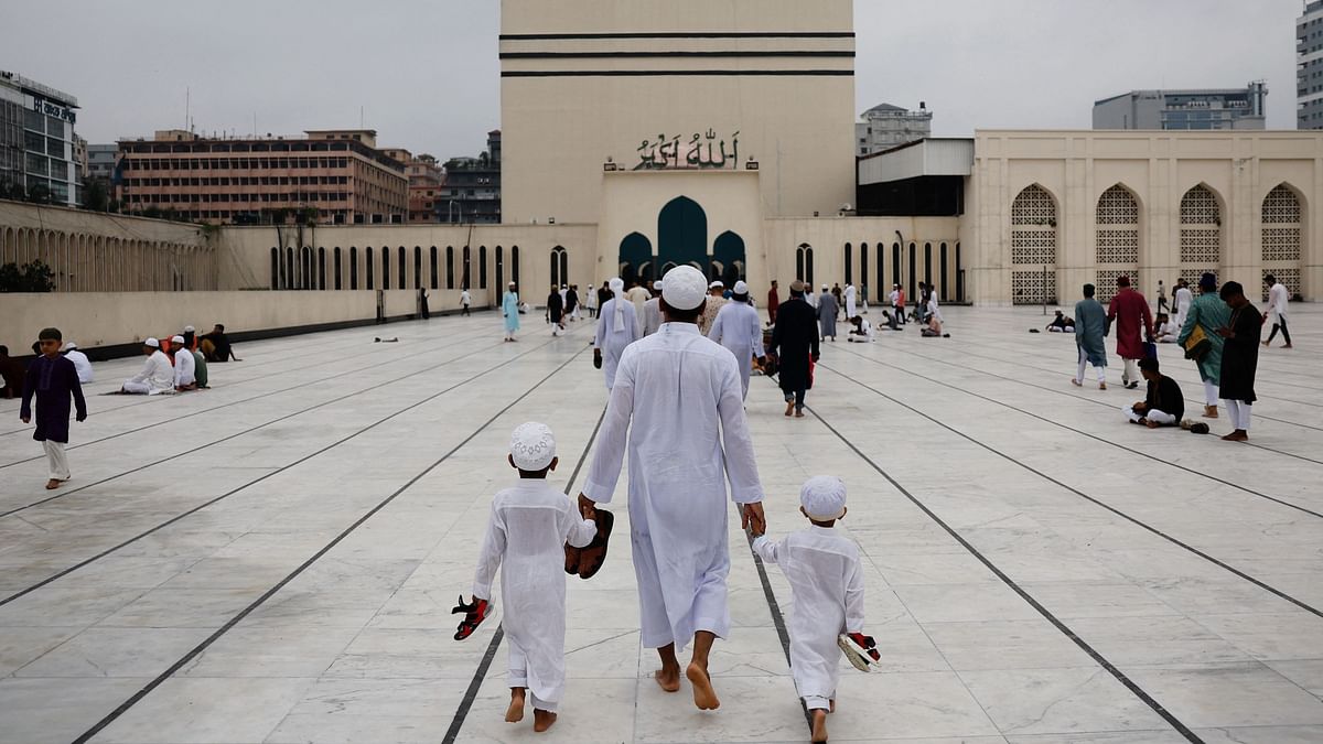 A family arrives at Baitul Mukarram National Mosque to attend Eid-ul-Adha prayer in Dhaka, Bangladesh.