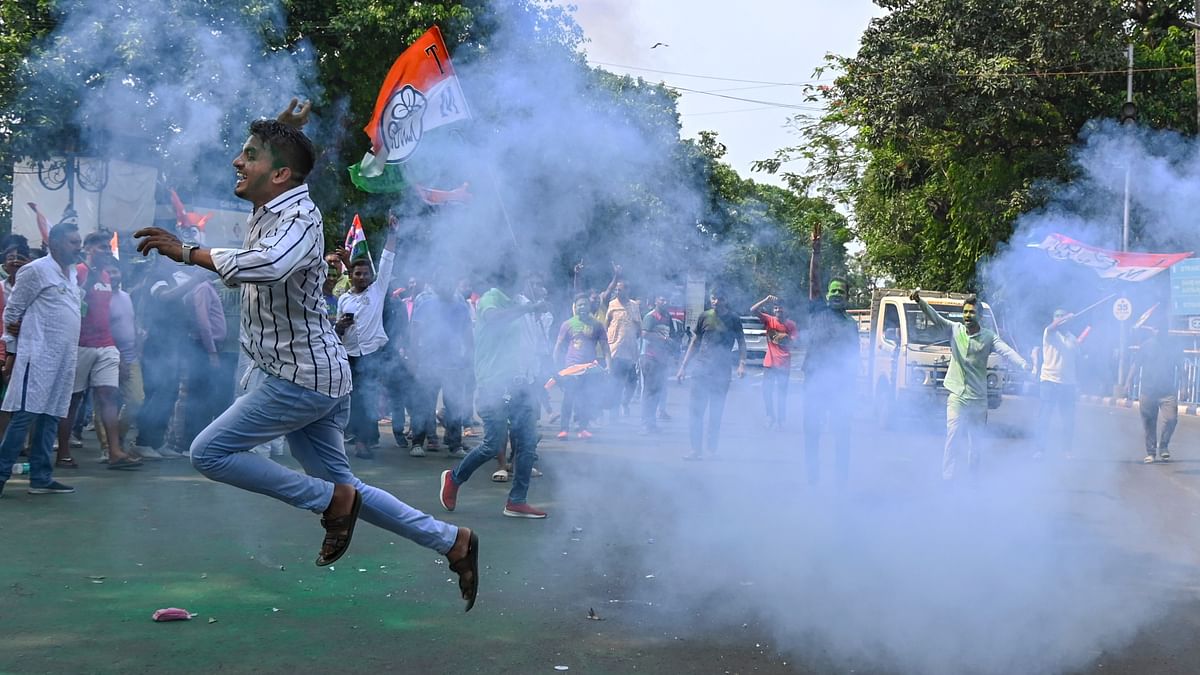 Trinamool Congress (TMC) supporters celebrate the party's lead in the Lok Sabha elections on the day of the counting of votes, near a counting center at Netaji Indoor Stadium, in Kolkata.