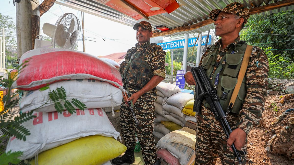 Security personnel stand guard outside a counting centre, a day before counting of votes for the Lok Sabha elections, in Jammu.