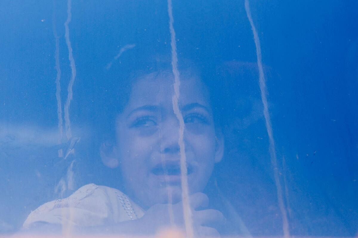 A Palestinian girl, who is a patient, cries while sitting inside a vehicle, before she is transferred for treatment abroad without being accompanied by her parents, through the Kerem Shalom crossing, amid the Israel-Hamas conflict, in Khan Younis in the southern Gaza Strip June 27, 2024.