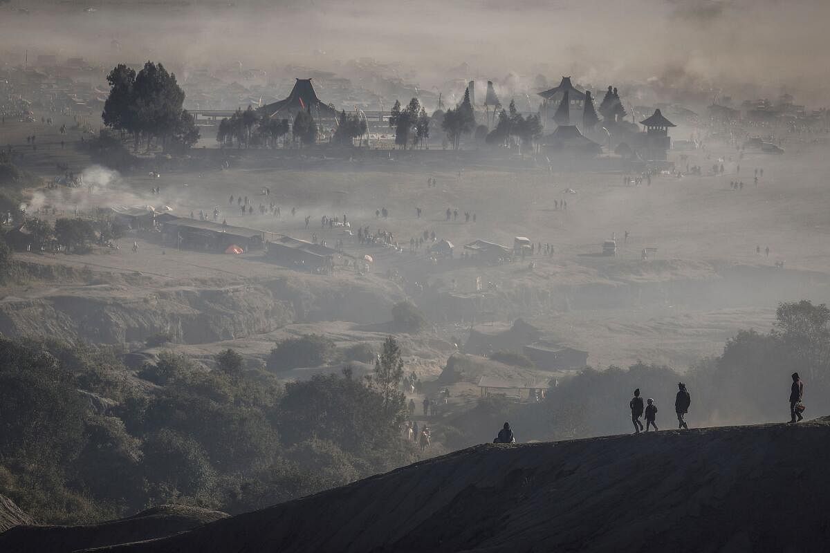 Luhur Poten Temple is surrounded by dust as Tenggerese Hindu worshippers and villagers gather at Mount Bromo's crater to throw their offerings, during the Yadnya Kasada festival in Probolinggo, East Java, Indonesia, June 22, 2024.