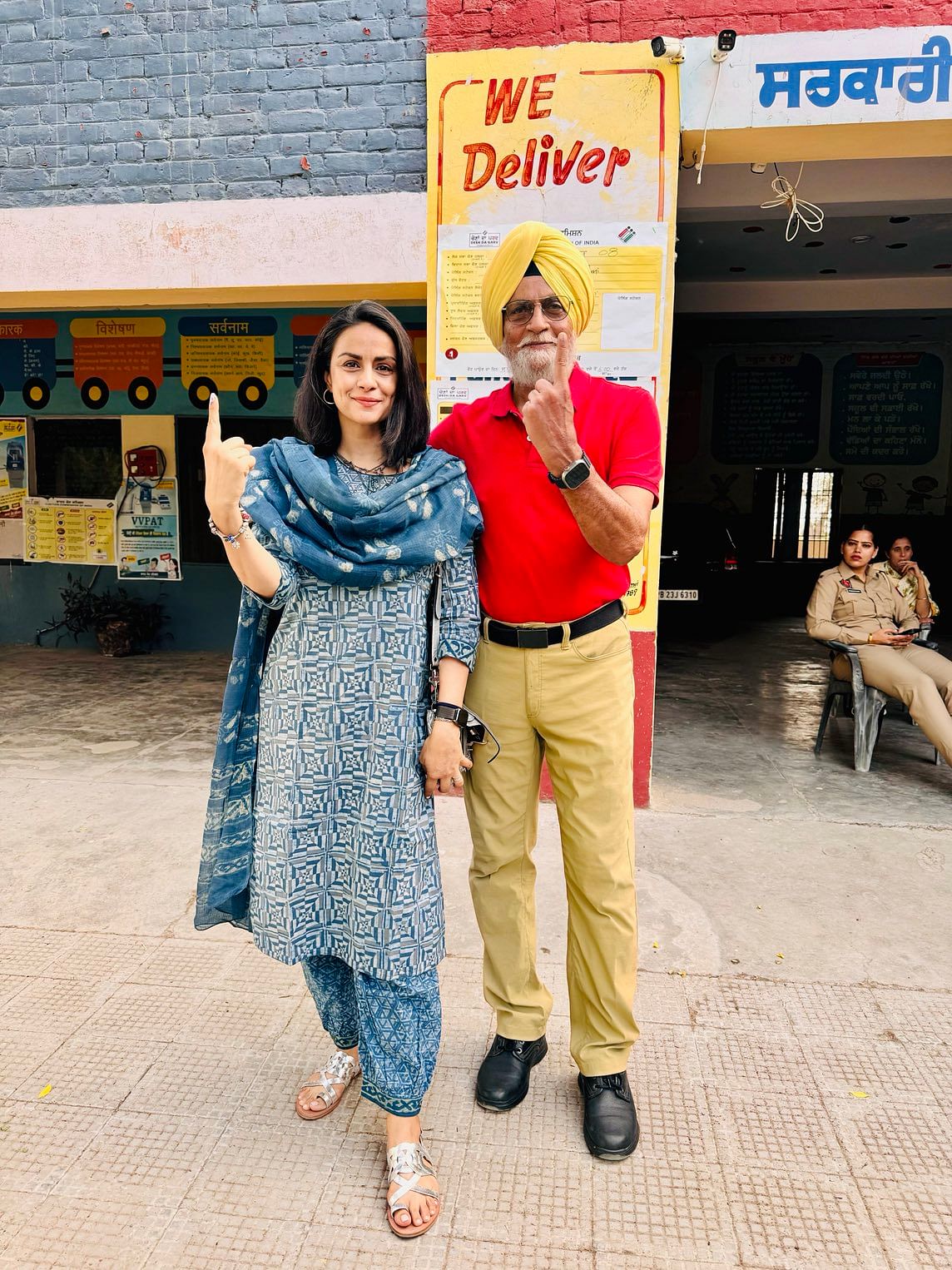 Actress Gul Panag flaunts her inked finger with father retd. Lt. Gen Harcharanjit Singh Panag outside a polling booth in Punjab. 