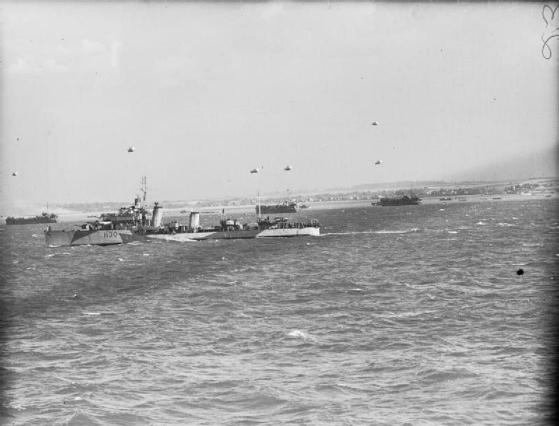 The destroyer HMS Beagle, moored off GOLD Area, as landing craft make for the beaches, June 6, 1944.