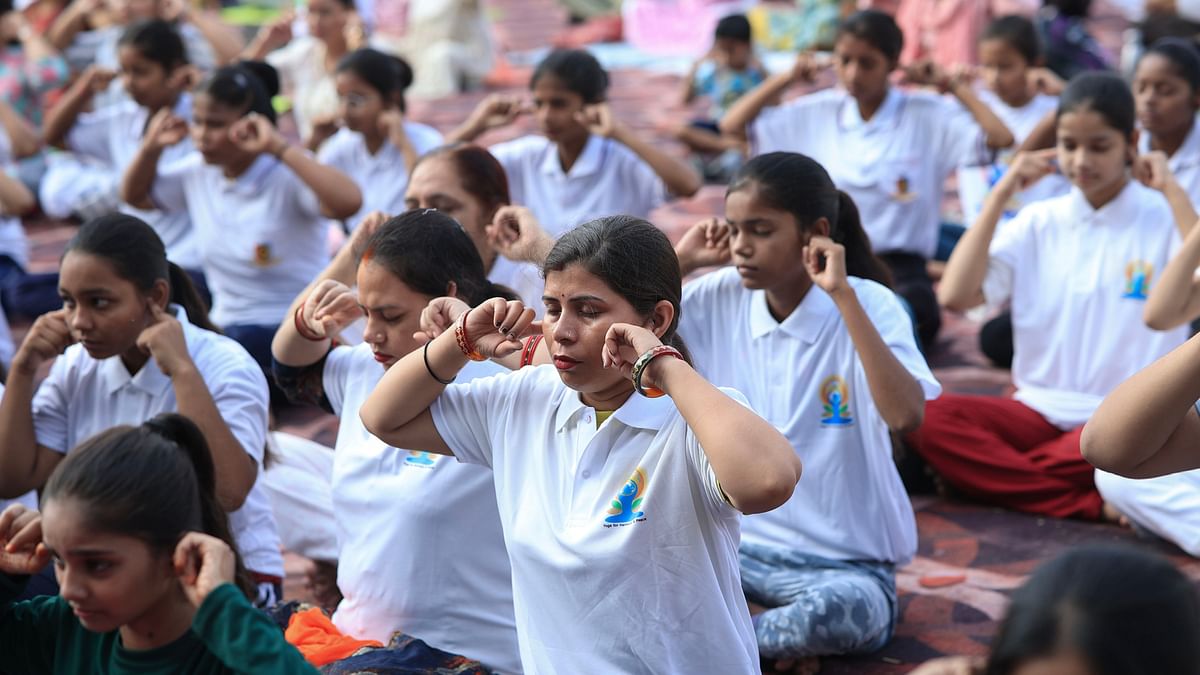 People perform yoga on the 10th International Day of Yoga, in Kanpur.