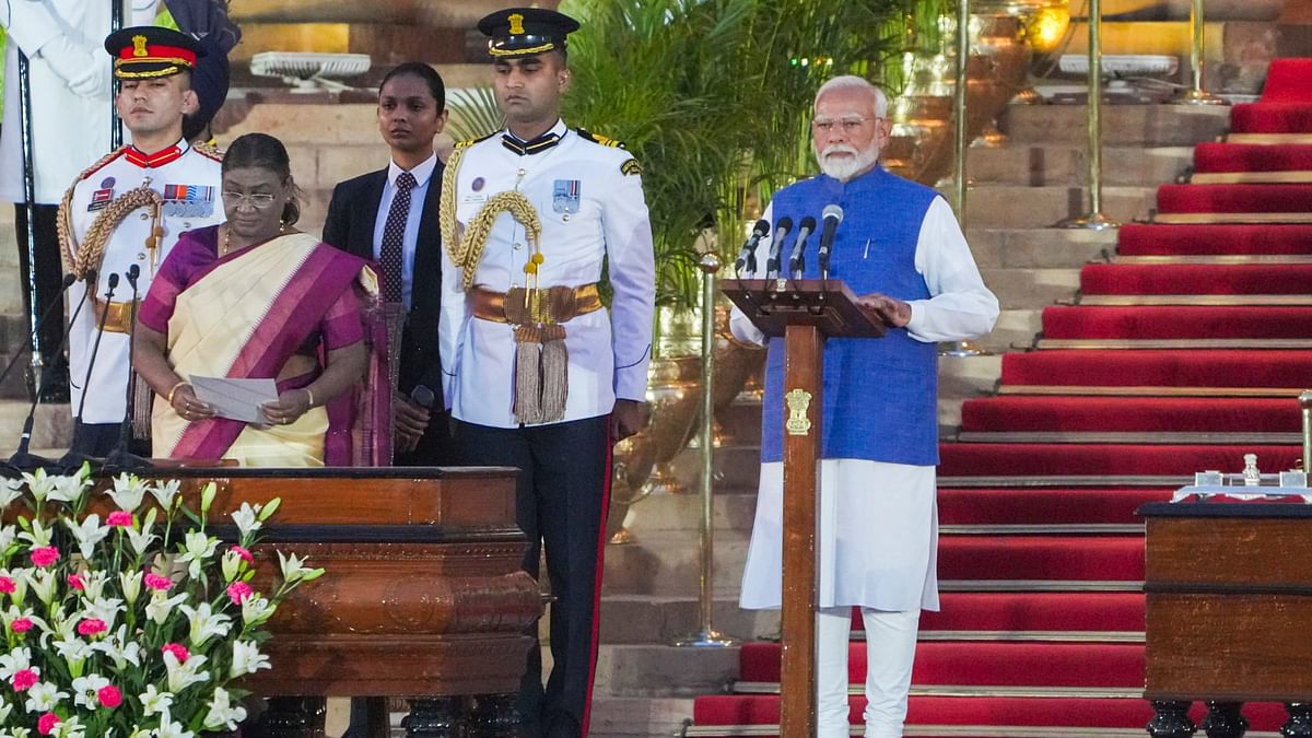 President Droupadi Murmu administers the oath of office to Narendra Modi as prime minister, at Rashtrapati Bhavan in New Delhi.