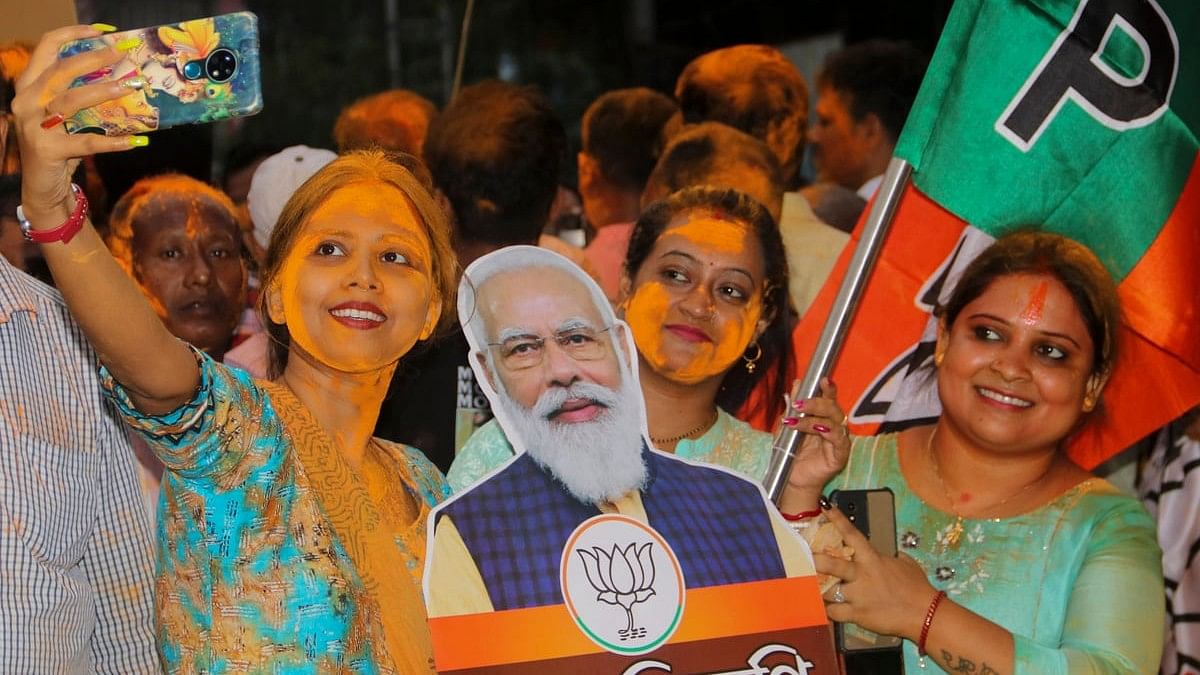BJP supporters celebrate before the swearing-in-ceremony of Prime Minister-designate Narendra Modi, at Balurghat in South Dinajpur, West Bengal.