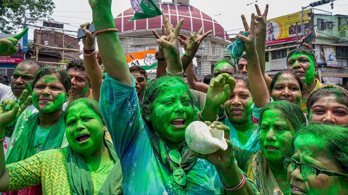 TMC supporters celebrate the party's lead during counting of votes for Lok Sabha elections, outside party supremo Mamata Banerjee's Kalighat residence, in Kolkata.