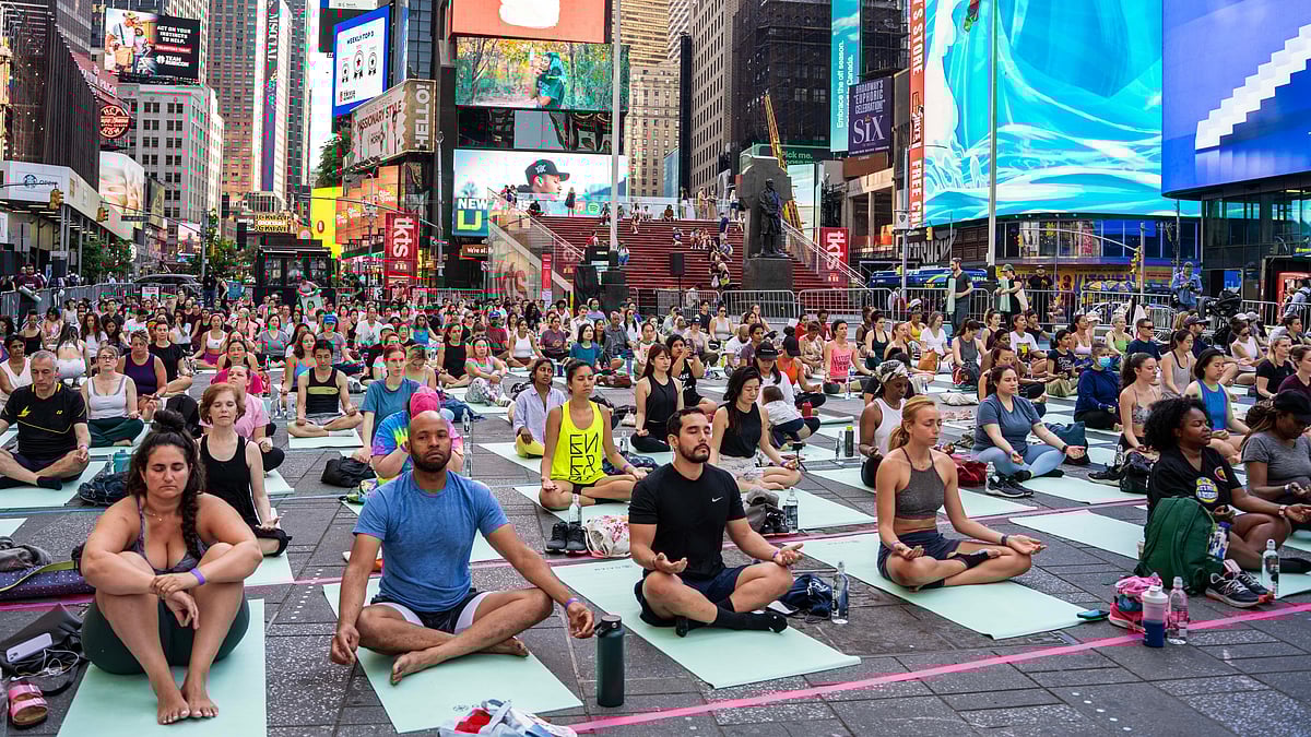 People practice yoga in Times Square in New York as part of a program organized to celebrate the 10th International Day of Yoga.