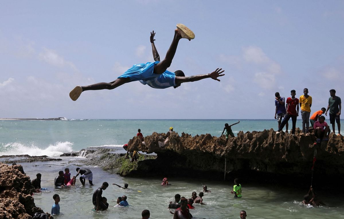 A man jumps into the Indian Ocean waters to join other revellers in Hamarweyne district of Mogadishu, Somalia June 7, 2024. 