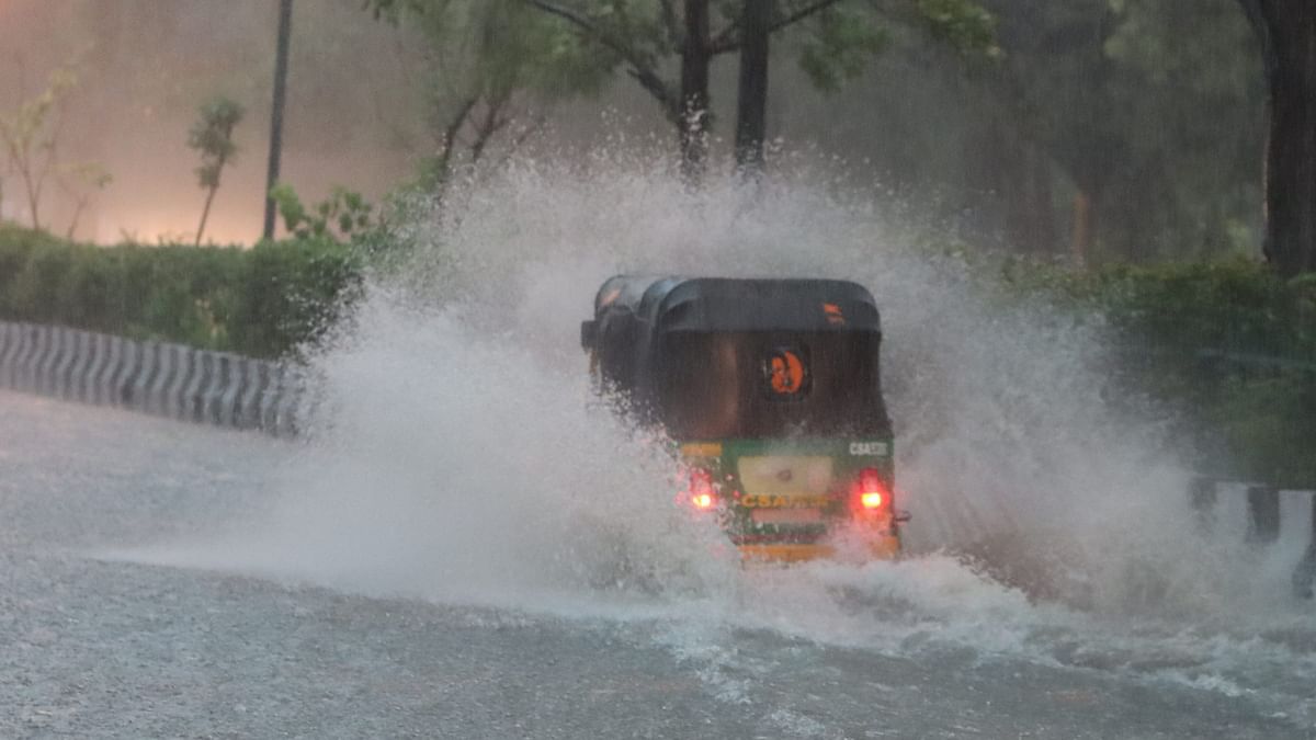An auto-rickshaw wades through a waterlogged road after heavy rains, in New Delhi.