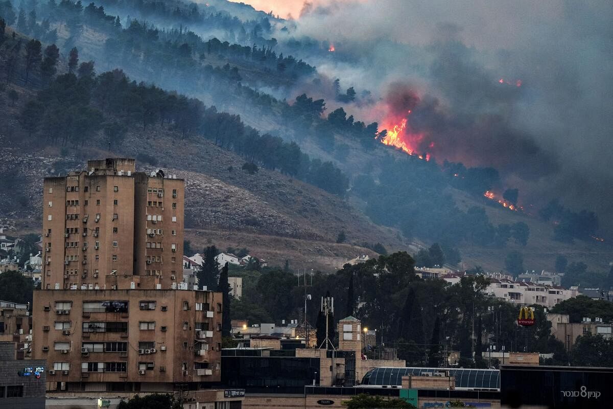 Smoke and fire covers the area following rocket attacks from Lebanon, amid ongoing cross-border hostilities between Hezbollah and Israeli forces, near Kiryat Shmona, Israel, close to its border with Lebanon, June 3, 2024.