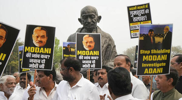 This March 2023 file photo shows Opposition MPs holding a protest over the Adani issue near the Gandhi statue at Parliament House complex in New Delhi. The Congress has claimed that the idea behind relocating the statues of Mahatma Gandhi, B R Ambedkar and Chhatrapati Shivaji among others is to ensure that they are not in a prominent place where the MPs could conduct peaceful and democratic protests.