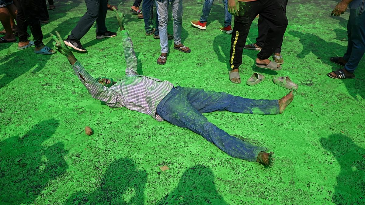 A Trinamool Congress (TMC) supporter celebrates the party's lead in the Lok Sabha elections on the day of counting of votes, near a counting center at Netaji Indoor Stadium, in Kolkata.