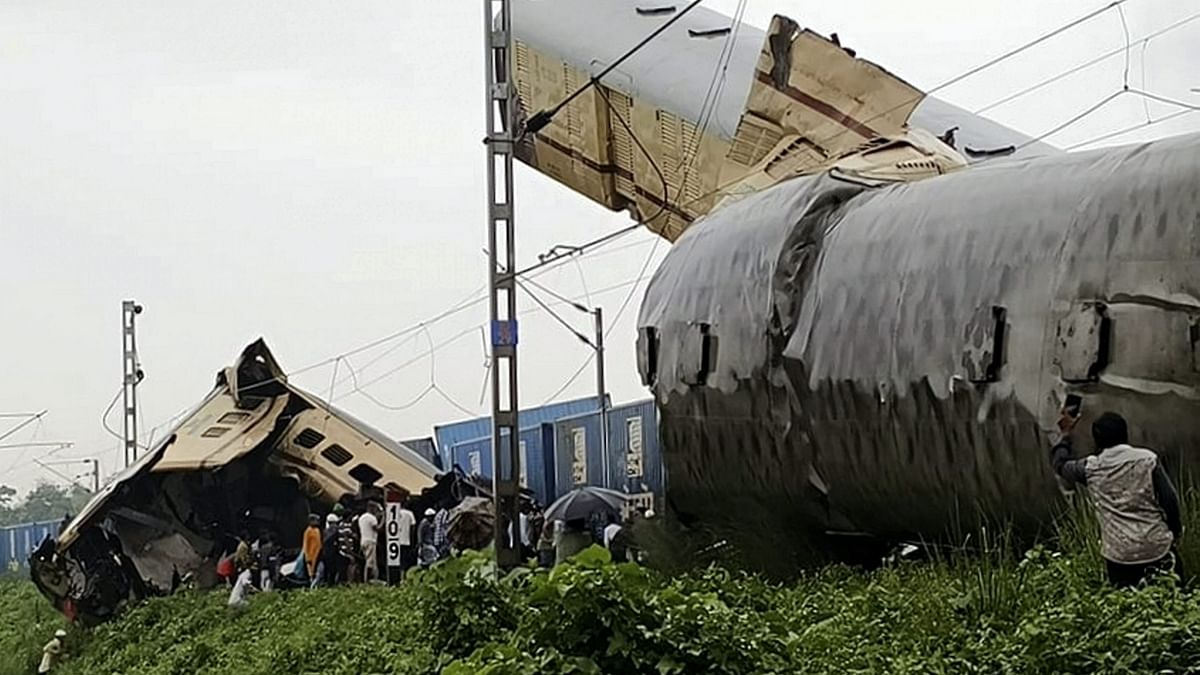 Locals gather at the accident site after a collision between the Kanchanjungha Express and a goods train, near Rangapani railway station in West Bengal.