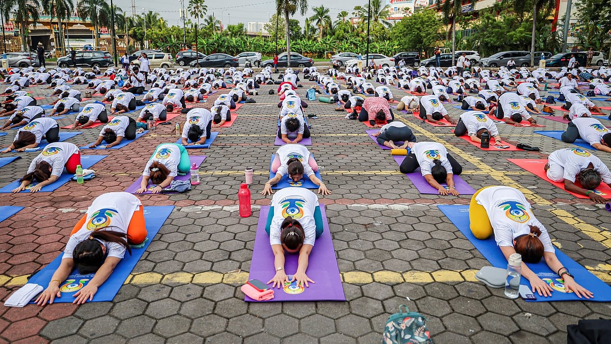 People take part in a mass yoga session during the 10th International Day of Yoga at Batu Caves, Malaysia.