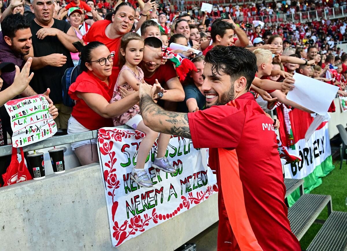 Hungary's Dominik Szoboszlai celebrates with fans.