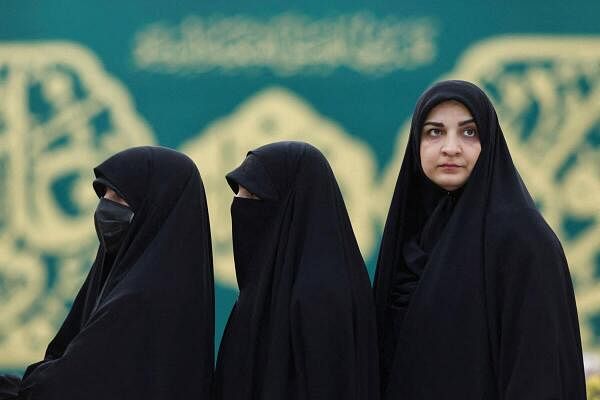 Iranian women line up to vote at a polling station in early presidential elections to choose a successor to Ebrahim Raisi after his death in a helicopter crash, in Tehran, Iran, June 28, 2024. 