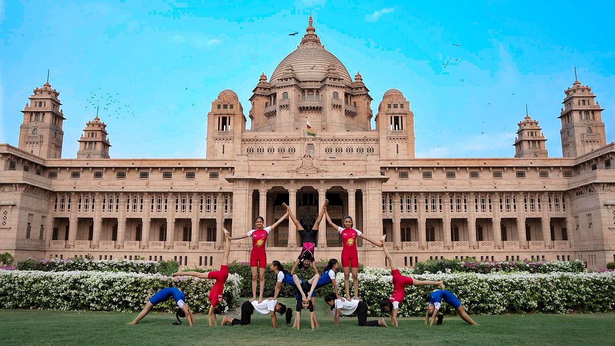 Young people perform yoga near Umaid Bhawan Palace in Jodhpur on the occasion of the 10th International Yoga Day.