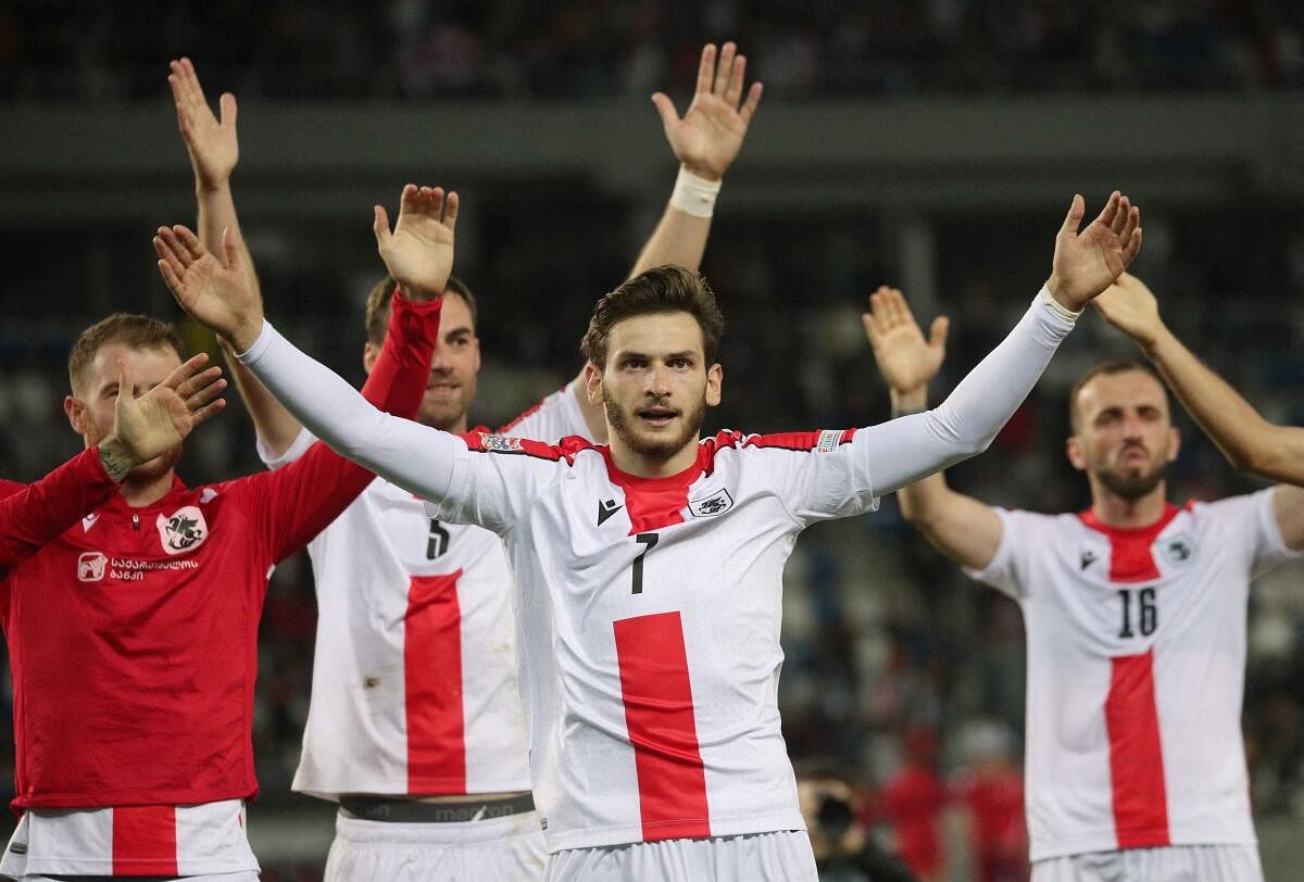 Georgia's Khvicha Kvaratskhelia celebrates after a match with teammates.