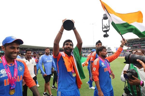 Jasprit Bumrah celebrates with the trophy alongside his team members. Bumrah, who had bowled a beauty to dislodge Reeza Hendricks in the powerplay, made an impact when he was eventually brought back for this remaining two overs, picking up a wicket and conceding only six runs off his final 12 balls.