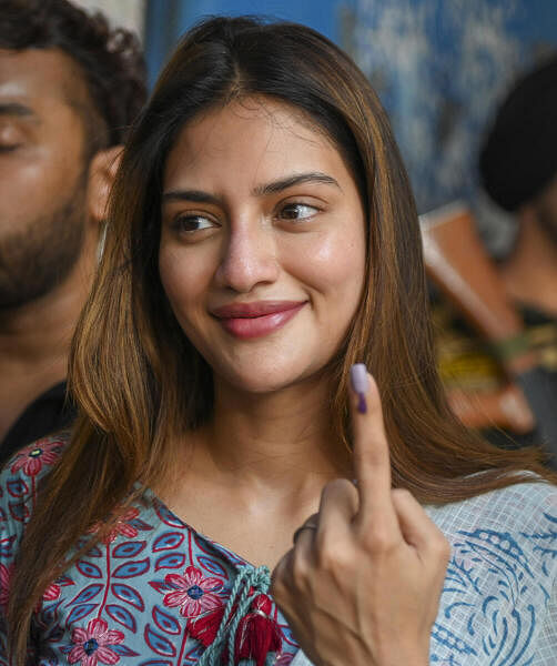 Actor and TMC leader Nusrat Jahan shows her inked finger after casting her vote  in Kolkata.