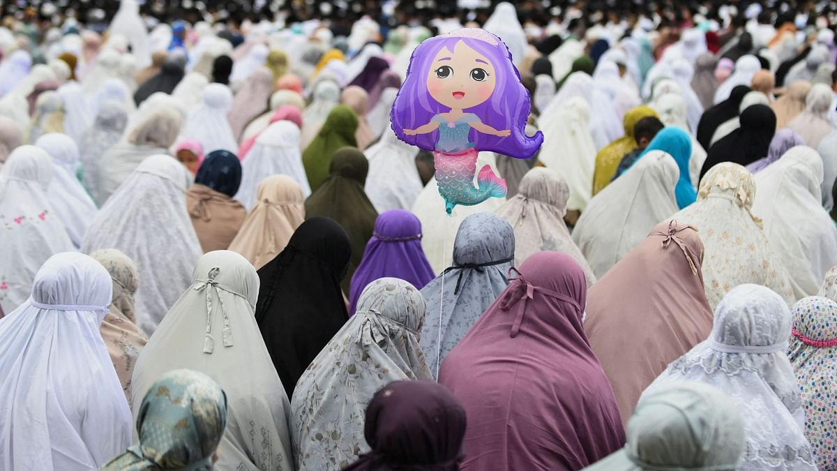 A balloon is seen amongst Muslims attending mass prayers during Eid ul-Adha celebrations in Banda Aceh, Indonesia.