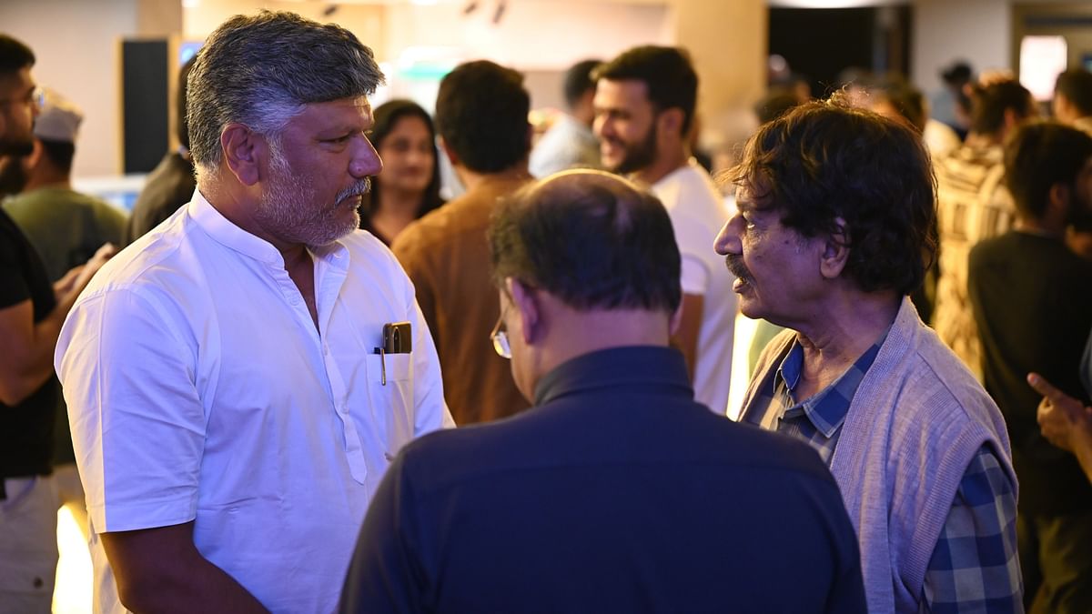 Ramesh Indira is seen with guests during the premiere of Kotee in Bengaluru.