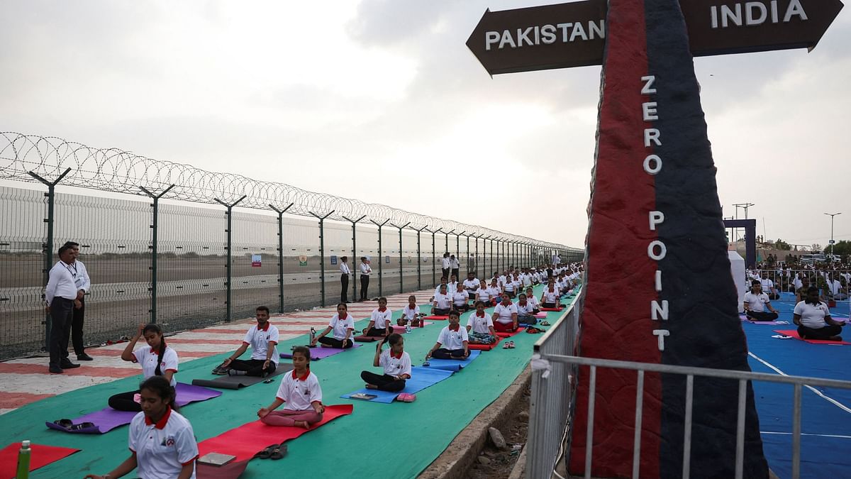 Participants perform yoga during the International Yoga Day at the India-Pakistan border in Nadabet, India.