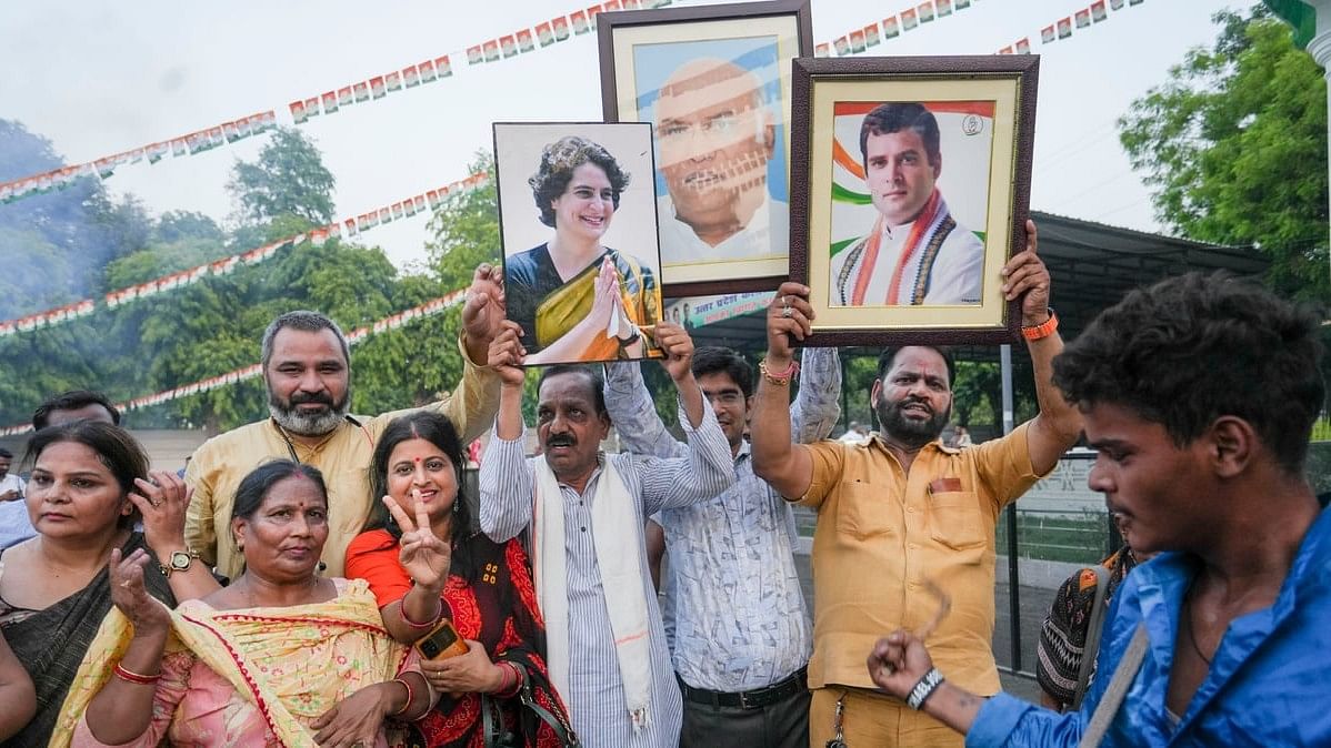 Congress workers celebrate the party’s lead in the Lok Sabha elections amid the counting of votes, at the party office, in Lucknow.