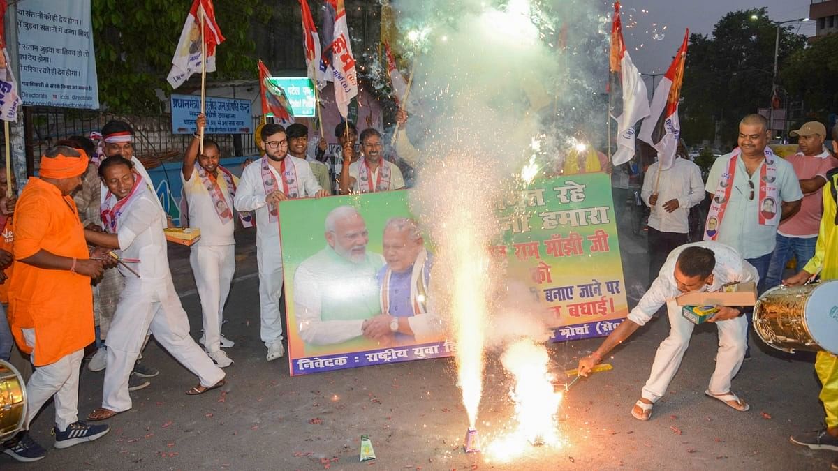 Supporters of HAM(S) celebrate the swearing-in-ceremony of Prime Minister-designate Narendra Modi, in Patna.