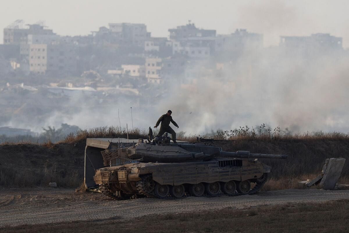 An Israeli soldier stands on top of a tank, amid the Israel-Hamas conflict, near the Israel-Gaza border, in Israel, June 23, 2024.