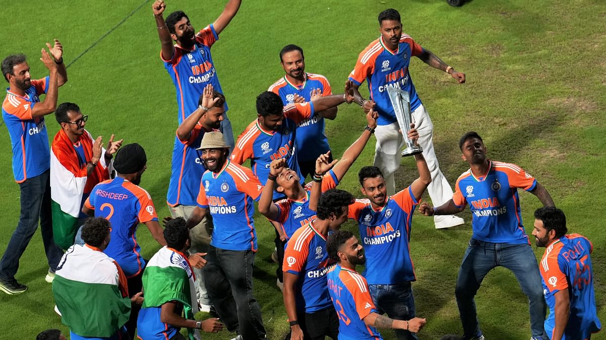 Cricketers dance during a felicitation ceremony at the Wankhede Stadium, in Mumbai.