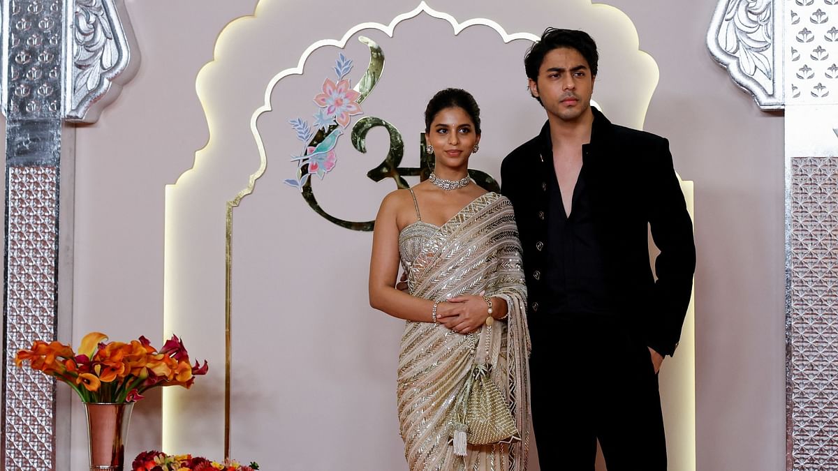 SRK's children Suhana Khan and Aryan Khan pose for the photographs they arrive for Anant Ambani and Radhika Merchant's wedding.