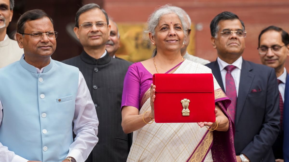 Finance Minister Nirmala Sitharaman on Tuesday carrying the digital tablet wrapped in  a traditional 'bahi-khata' style pouch as she headed to Parliament to present the Union Budget 2024 in a paperless format just like the previous years.