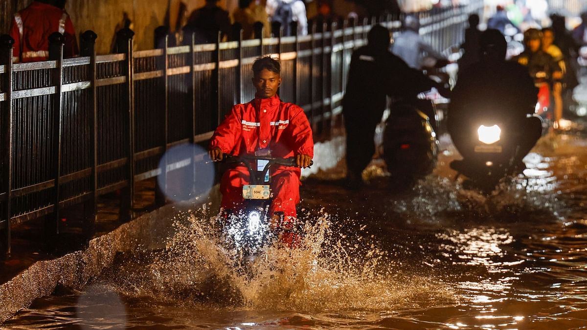 Commuters waded through knee-deep water that partially submerged vehicles in many areas, as traffic piled up on the city's Eastern and Western Express highways.