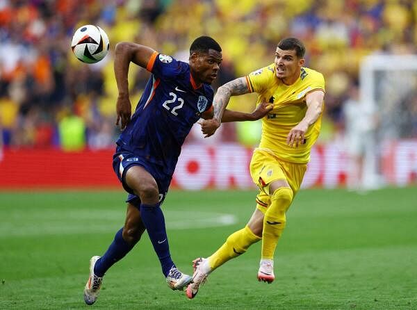 Euro 2024 - Round of 16 - Romania v Netherlands - Munich Football Arena, Munich, Germany - July 2, 2024 Netherlands' Denzel Dumfries in action with Romania's Valentin Mihaila 