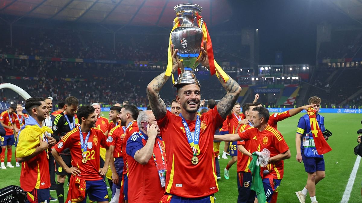 Spain's Joselu celebrates with the trophy.