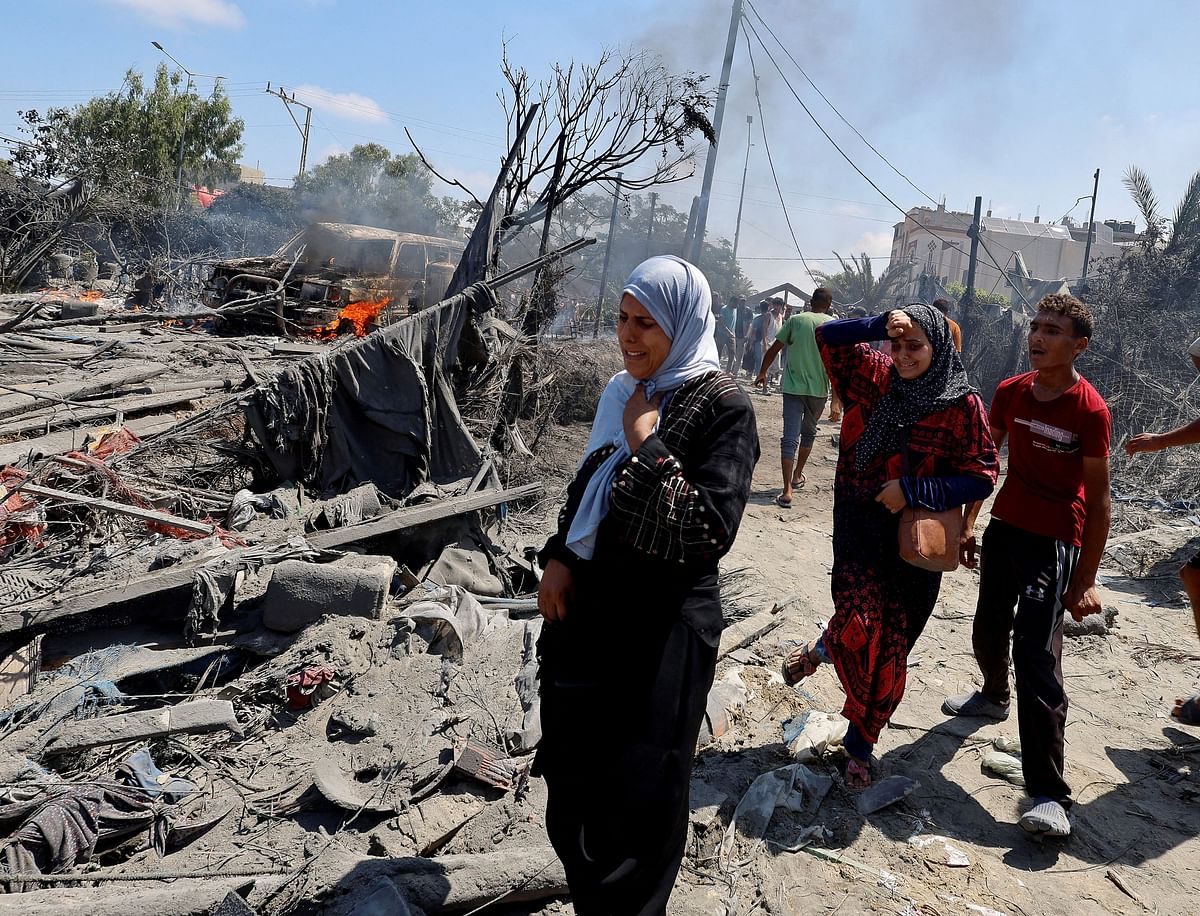 Palestinians react near damage, following what Palestinians say was an Israeli strike at a tent camp in Al-Mawasi area, amid Israel-Hamas conflict, in Khan Younis in the southern Gaza Strip July 13, 2024.