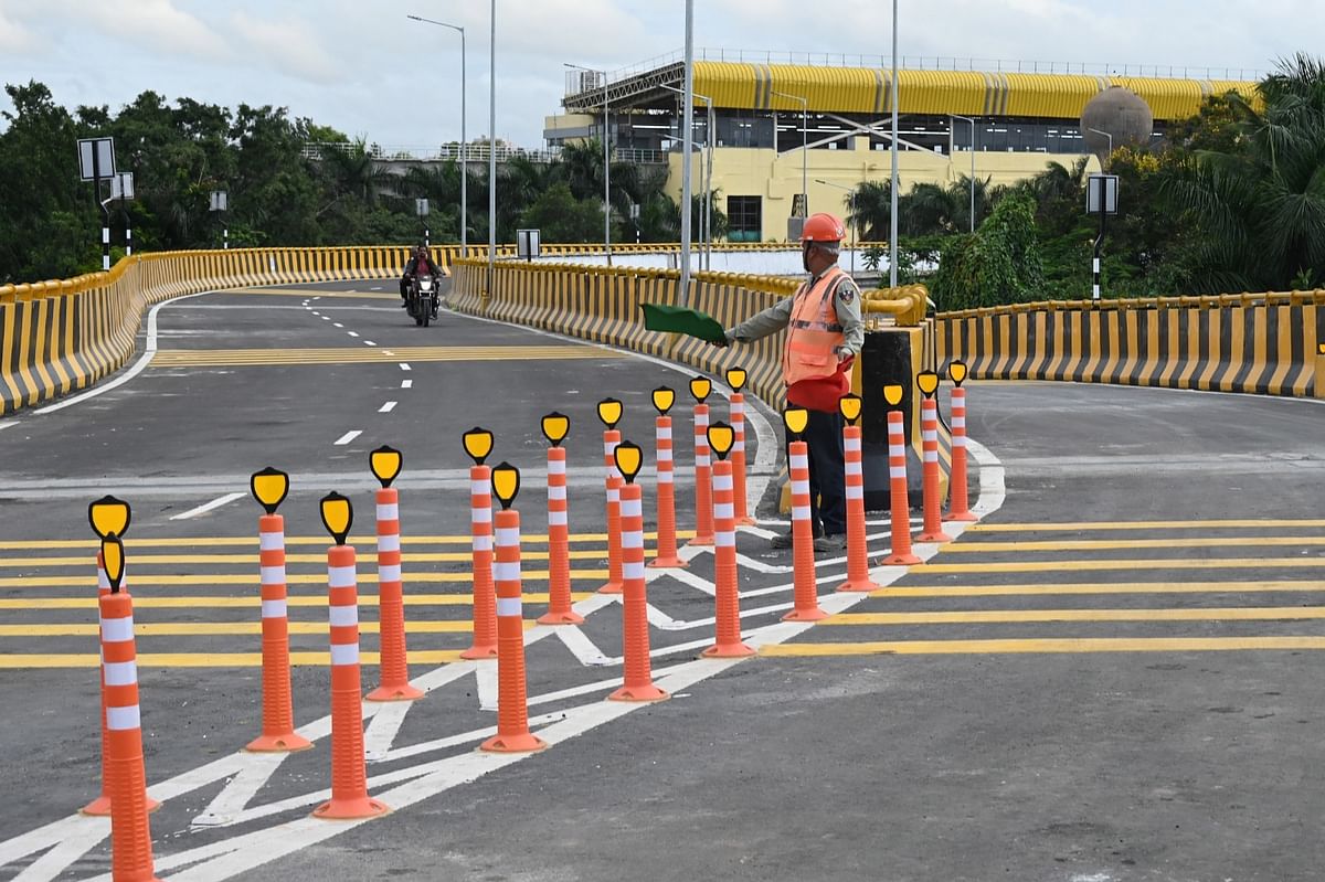 Workers close one of the three U-turns on the double-deck flyover on Wednesday, July 17, 2024.