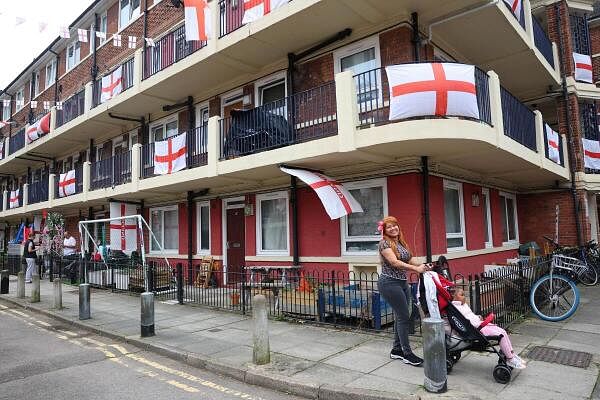 A resident reacts as she walks through the Kirby Estate, decorated ahead of the UEFA Euro 2024 final between England and Spain, in London, Britain on July 12, 2024.